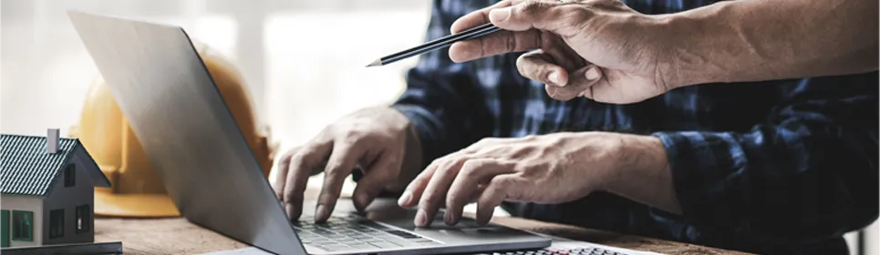 contractors looking over financial reports on a computer